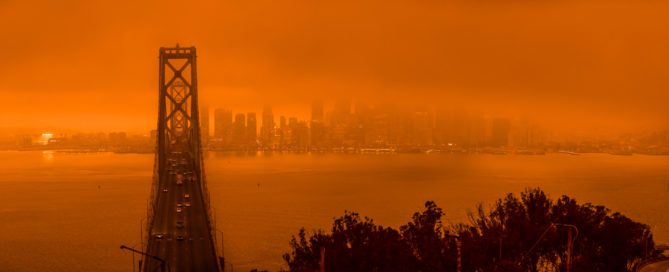 Bay Bridge and San Francisco city scape in a smokey orange glow