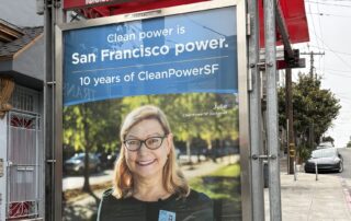 bu stop shelter on San Francisco street with image of middle-aged, blond medium length hair woman smiling